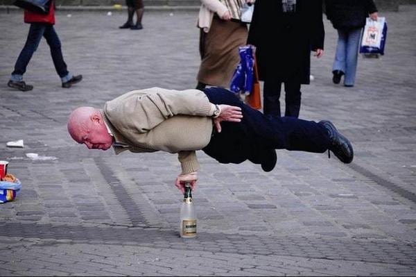 man balancing on bottle