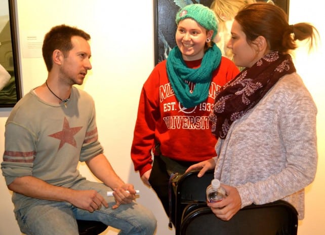 Cody speaking to two female students.