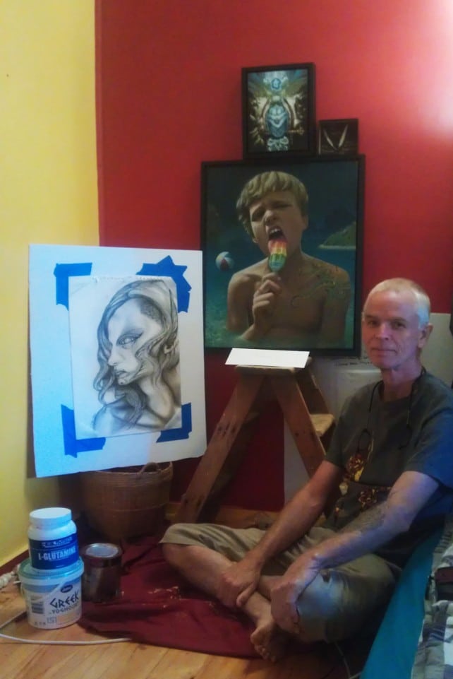 Stephan sitting with his newest Seekins' artworks at his residence.